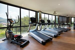 a row of cardio machines in a gym with windows at Tropics Kamala Hill View Studio CTG P613 near Beach and Fantasea in Kamala Beach