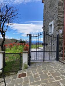 a black iron gate with a view of the ocean at Casa Vanna in Carrodano Superiore