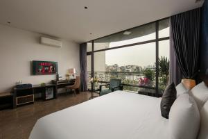 a hotel room with a bed and a large window at Westlake Pearl Suites & Spa 70 Xuan Dieu - By Pegasy Group in Hanoi