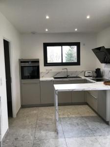 a kitchen with a sink and a window at Charmante villa neuve à Chaspuzac in Chaspuzac +8 photos