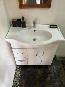 a white sink in a bathroom with a mirror at Shri Wedari Private Pool with Ricefield View in Tampaksiring +23 photos