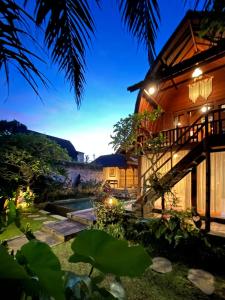 a view of a house at night with lights at Shri Wedari Private Pool with Ricefield View in Tampaksiring