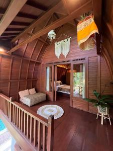 an inside view of a room with a bed in a house at Shri Wedari Private Pool with Ricefield View in Tampaksiring