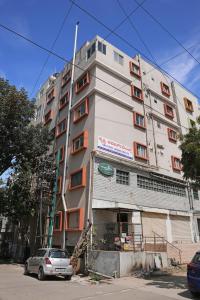 a building with a car parked in front of it at Premium Two Bedroom Apartment in Bengaluru
