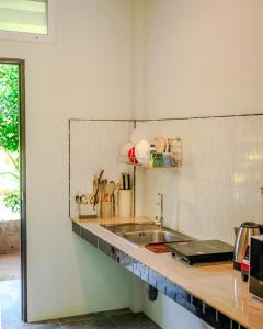 a kitchen with a sink and a counter top at Charming Condo - 2mn ZenBeach - Heart of Srithanu - 4K SmartTV in Ko Kong Nui +16 photos