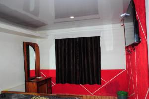 a stage with a black curtain and a mirror at Bethany stay in Ooty