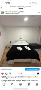 a bedroom with a bed with two towels on it at Centar Jezero Zlatibor klimatizovano in Zlatibor