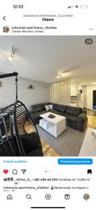 a living room with a couch and a table at Centar Jezero Zlatibor klimatizovano in Zlatibor