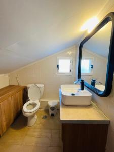 a bathroom with a white toilet and a sink at Blue Pearl Beach House in Sozopoli +24 photos