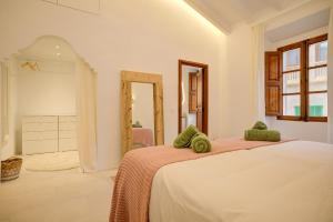 a bedroom with a large bed and a bathroom at San Francisco by Rentallorca in Petra