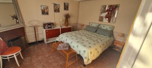 a bedroom with a bed and a table and a chair at Vintage in Perpignan in Perpignan