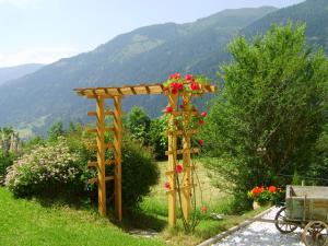a wooden pergola with flowers on it in a field at Kolarnock in Feld am See