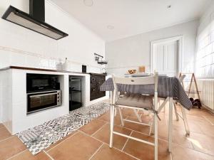 a kitchen with a table and chairs in a room at La Casuca de Orejo - Monabri in Orejo
