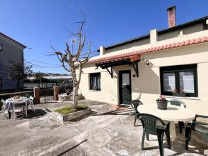 a patio with a table and chairs in front of a house at La Casuca de Orejo - Monabri in Orejo