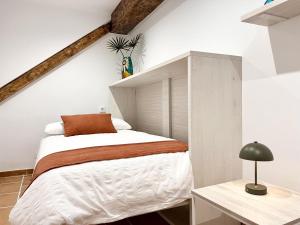 a small bedroom with a bed and a desk at La Casuca de Orejo - Monabri in Orejo