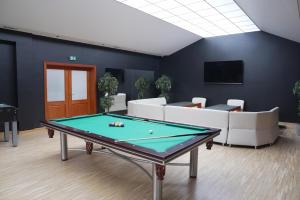 a billiards table in a room with couches at Hotel Reśliński in Grodzisk Wielkopolski