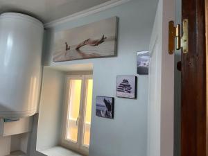 a hallway with a window and pictures on the wall at Appartement au cœur de Mirepoix in Mirepoix