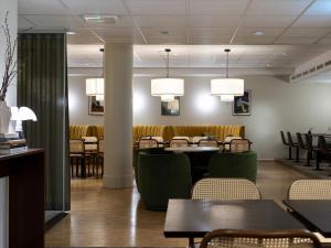 a dining room with tables and chairs and lights at Elite City Hotel, Örebro in Örebro