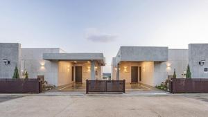 a building with benches in a parking lot at Yeoncheon Bell 37 Pool Villa in Yeoncheon