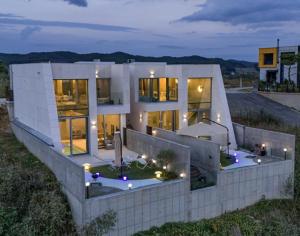 a large house with lights on the side of it at Yeoncheon Bell 37 Pool Villa in Yeoncheon
