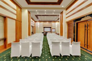 a conference room with white chairs and a table at The Fern-An Ecotel Hotel, Kochi in Cochin +53 photos