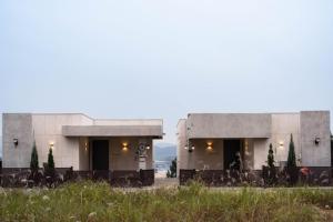 a building with tables and chairs in a field at Yeoncheon Bell 37 Pool Villa in Yeoncheon +145 photos