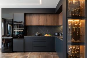 a kitchen with black counters and wooden cabinets at Villa Betelgeuse Supernova - Happy Rentals in Novi Vinodolski