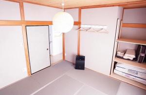 a room with two doors and a speaker in it at 遊びの宿KONoさんち in Tateyama +4 photos