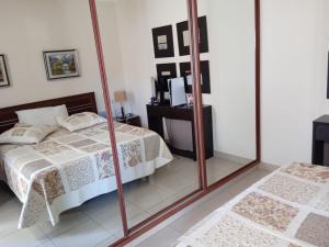 a bedroom with a bed and a mirror at Primavera Deluxe in Costa Del Silencio