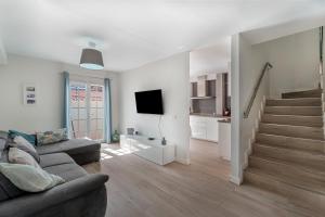 a living room with a couch and a staircase at Casa el Jable in Guía de Isora