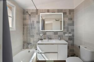 a bathroom with a sink and a toilet and a mirror at Casa el Jable in Guía de Isora +22 photos