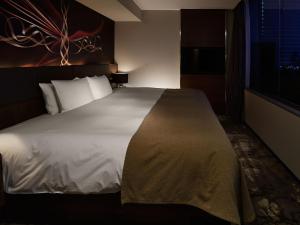 Postel nebo postele na pokoji v ubytování Akasaka Granbell Hotel