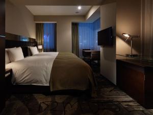 Postel nebo postele na pokoji v ubytování Akasaka Granbell Hotel