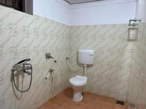 a bathroom with a toilet and a shower at Chandralayam Heritage Homestay in Bekal