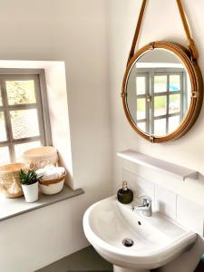 a bathroom with a sink and a mirror at North Cottage in Berriew
