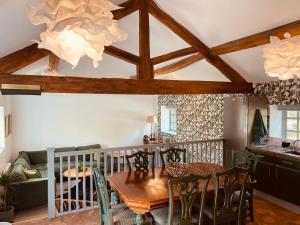 a dining room with a wooden table and chairs at North Cottage in Berriew