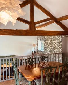 a dining room with a wooden table and chairs at North Cottage in Berriew +15 photos