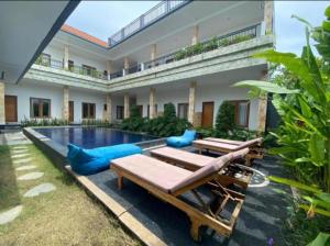 a villa with a swimming pool and a resort at Canggu Kayuma House in Canggu +24 photos