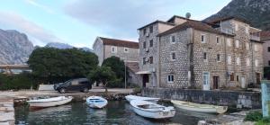 a group of boats in the water in front of a building at Studio 032 in Prčanj