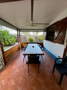 a dining area with a table and chairs in a room at villa créole avec piscine privée in Petit-Bourg +32 photos