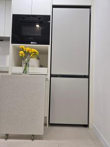 a kitchen with a white refrigerator and a microwave at Siaring2room in Seoul