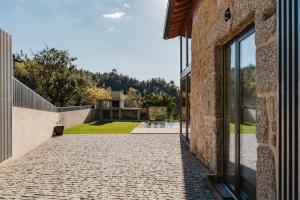 an external view of a house with a stone driveway at Dunas e Abraços in Braga