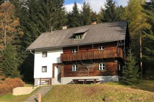 a large wooden house on top of a hill at Nockstern Hütte in Ebene Reichenau