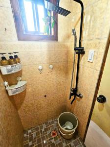 a small bathroom with a shower with a toilet at Transient Guest Room 3A Baguio Wifi Parking in Baguio