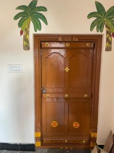 a wooden door in the corner of a room at Temple View in Bangalore