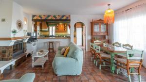a kitchen and living room with a couch and a table at Casa Paraiso Tropical Torrox by Ruralidays in Torrox