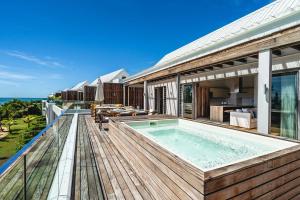 a house with a swimming pool on a deck at Aqua Serena - Luxury Beachfront Penthouse in Grand Gaube +28 photos