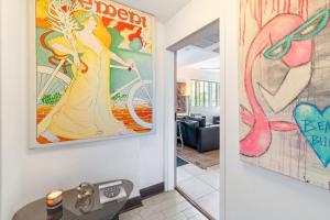 un pasillo con una pintura de una mujer en una bicicleta en Oceanfront Oasis 2-BR Apartment on Ocean Drive, en Miami Beach