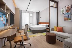 a hotel room with a bed and a desk at Home2 Suite by Hilton Hengshui Taocheng in Hengshui