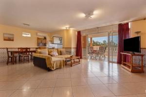 a living room with a couch and a tv at Casa Marron in Costa Calma